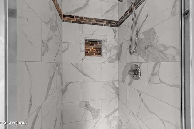 bathroom with a tile shower