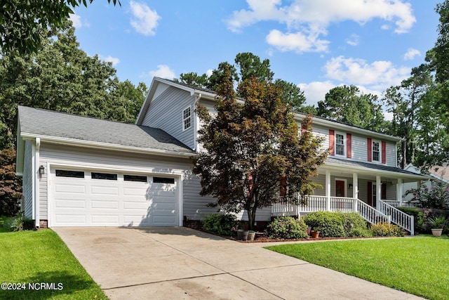 view of front of house featuring a garage, a front yard, and covered porch