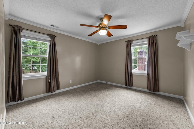 spare room with a textured ceiling, carpet flooring, ceiling fan, and crown molding