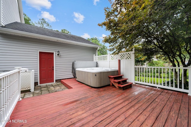 wooden deck with a hot tub