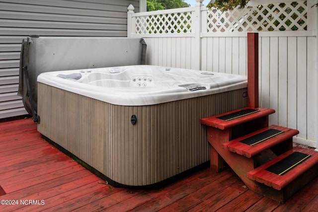 wooden terrace featuring a hot tub