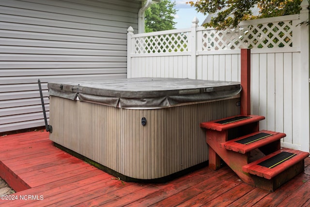 wooden terrace featuring a hot tub