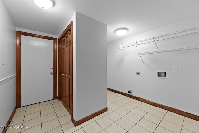 laundry area featuring hookup for an electric dryer, hookup for a washing machine, and light tile patterned floors