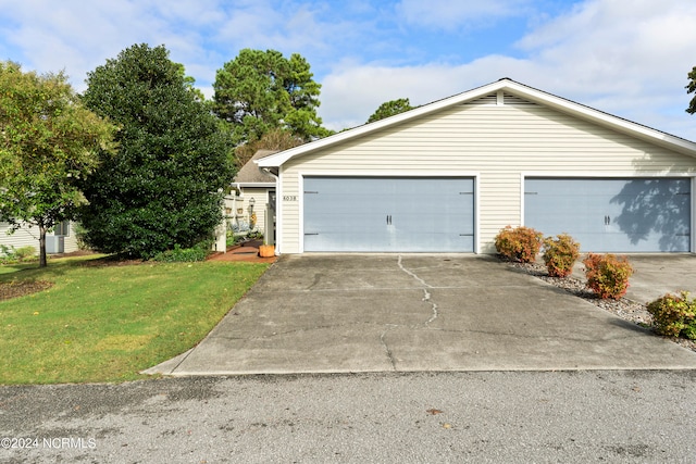 exterior space featuring a front lawn and a garage