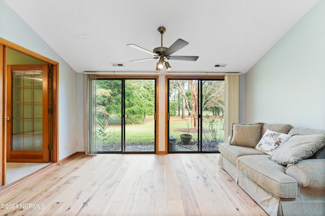 unfurnished living room with light hardwood / wood-style flooring, floor to ceiling windows, ceiling fan, and a wealth of natural light