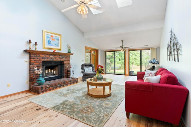 living room featuring a brick fireplace, ceiling fan, and hardwood / wood-style floors