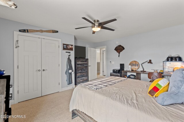 carpeted bedroom with a closet and ceiling fan