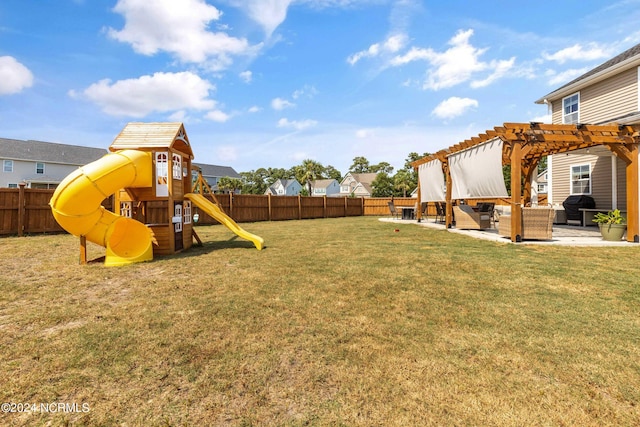 view of yard featuring a pergola, a patio area, and a playground