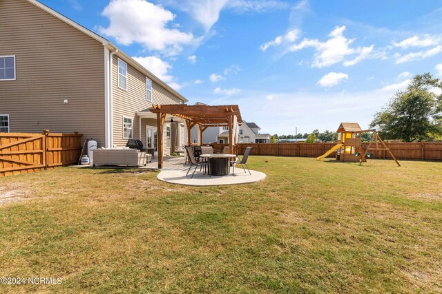 view of yard featuring a pergola, a patio area, and a playground