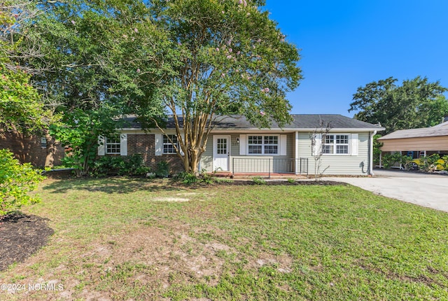 single story home with driveway and a front yard