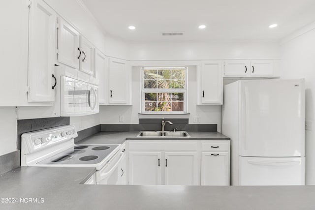 kitchen with white appliances, a sink, visible vents, white cabinetry, and dark countertops