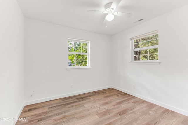 unfurnished room with plenty of natural light, ceiling fan, and light hardwood / wood-style flooring