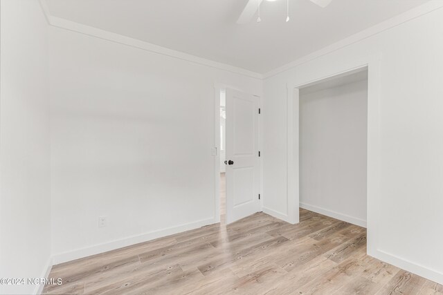 spare room featuring ceiling fan and light hardwood / wood-style flooring