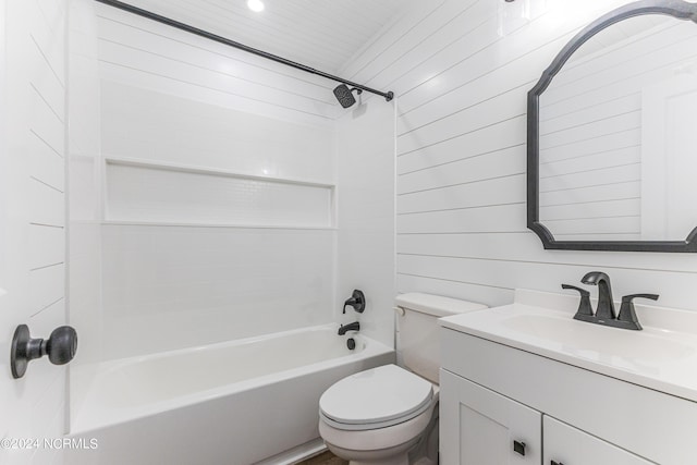 bathroom with wooden walls, vanity, toilet, and shower / bathtub combination