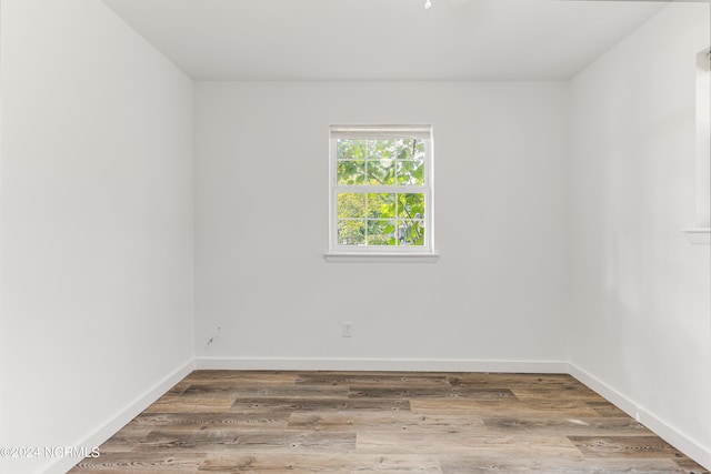 unfurnished room featuring baseboards and wood finished floors