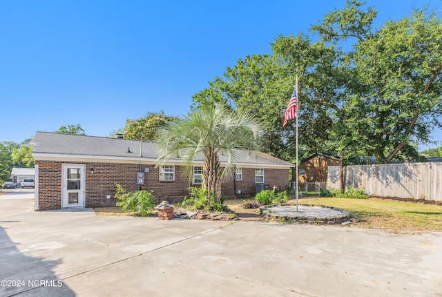 view of front facade featuring brick siding and fence