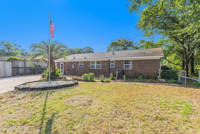 back of property with a patio area and a lawn