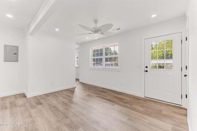 entryway with light wood-type flooring, ornamental molding, ceiling fan, and electric panel