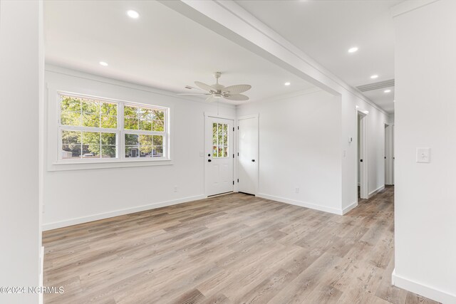 spare room featuring ceiling fan, crown molding, beamed ceiling, and light hardwood / wood-style floors