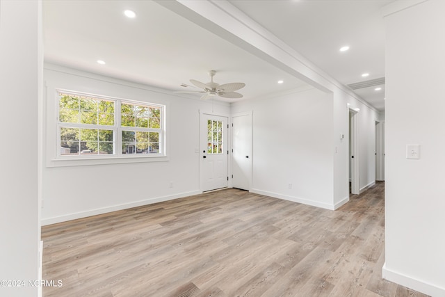 spare room featuring baseboards, a ceiling fan, light wood-style flooring, ornamental molding, and recessed lighting