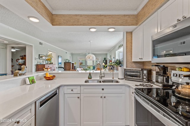 kitchen featuring a textured ceiling, stainless steel appliances, sink, and white cabinets