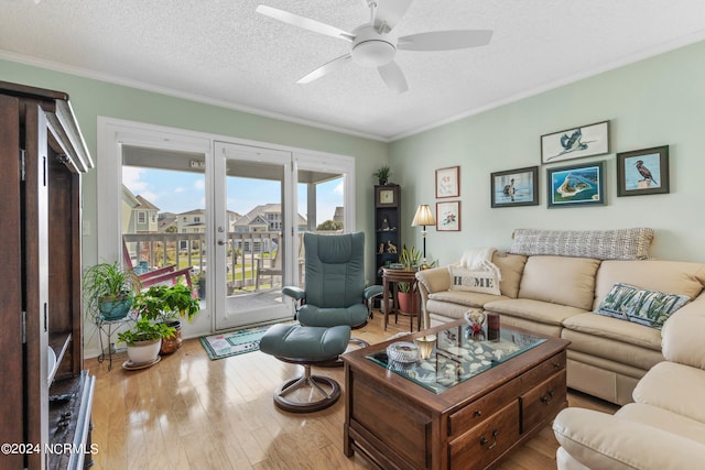 living room featuring crown molding, a textured ceiling, hardwood / wood-style floors, and ceiling fan