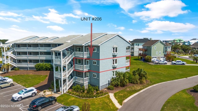 view of property featuring uncovered parking and a residential view