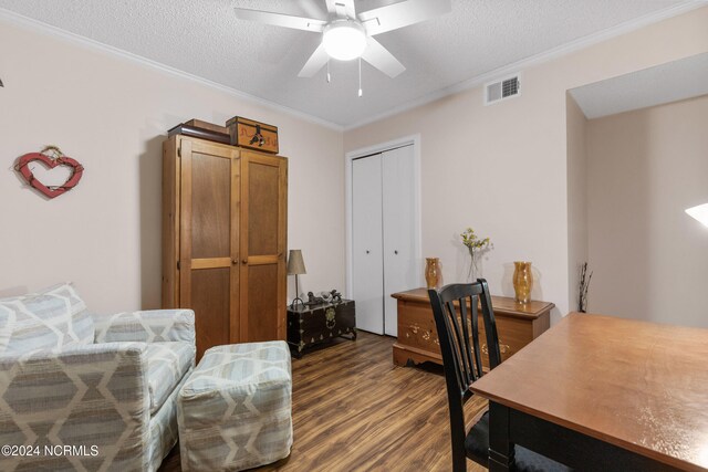 home office featuring ornamental molding, dark hardwood / wood-style flooring, ceiling fan, and a textured ceiling