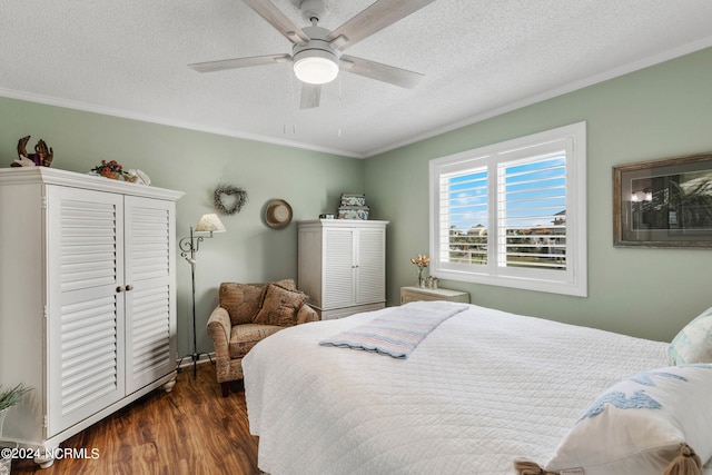 bedroom with crown molding, a closet, dark wood-type flooring, ceiling fan, and a textured ceiling