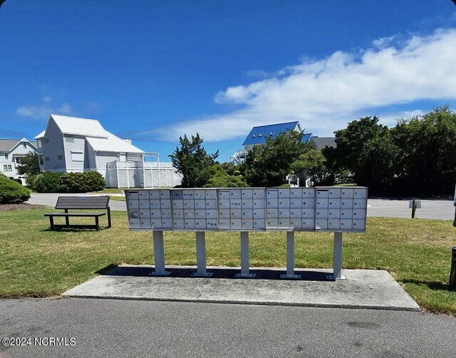 view of property's community with a yard and mail boxes