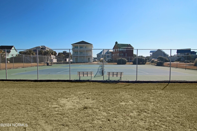 view of sport court featuring a lawn and fence