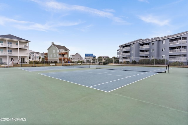 view of tennis court featuring fence