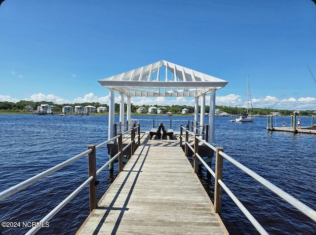 dock area with a gazebo and a water view