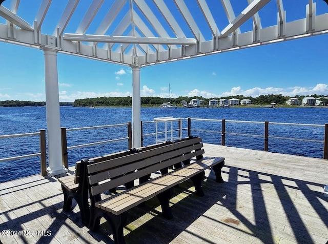 view of dock with a water view and a pergola