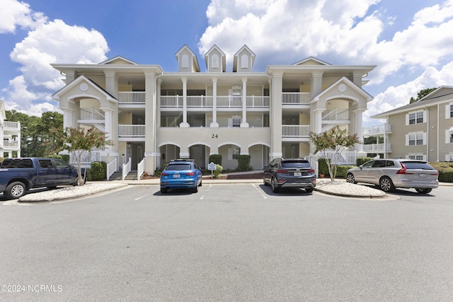 view of building exterior featuring uncovered parking