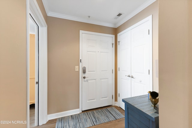 doorway to outside with light wood-type flooring and ornamental molding