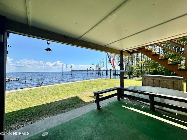 view of home's community with a yard and a water view