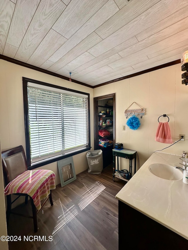 interior space with dark wood-type flooring, sink, wood ceiling, and ornamental molding