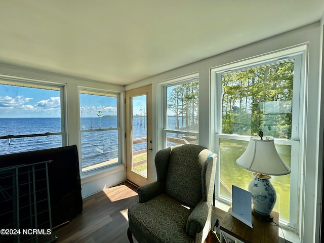 sunroom / solarium featuring a water view