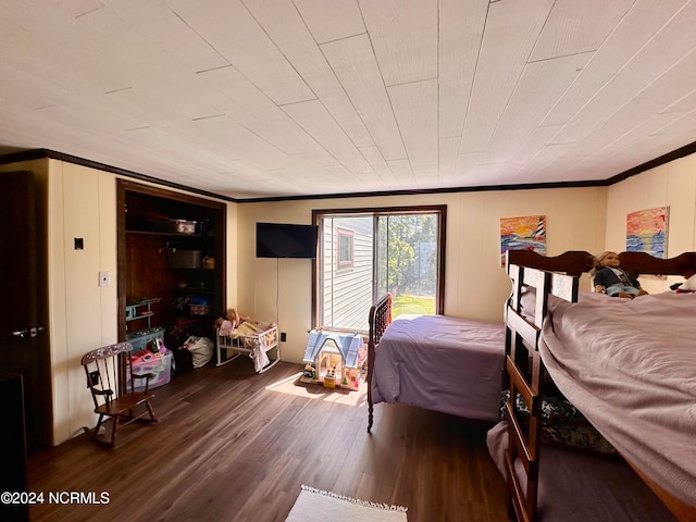 bedroom featuring hardwood / wood-style floors, ornamental molding, and wood ceiling