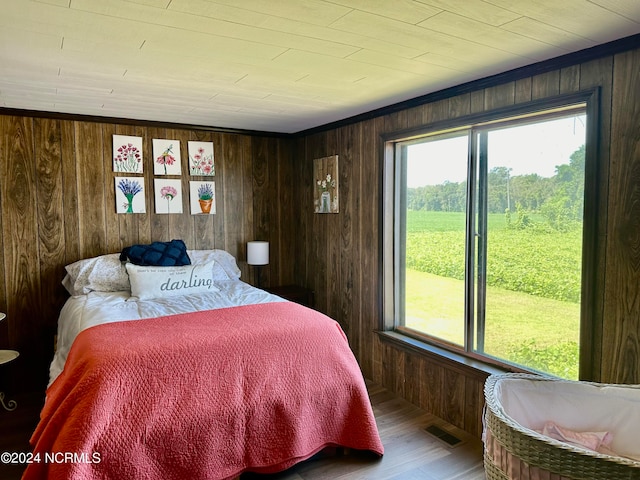 bedroom featuring hardwood / wood-style flooring, wood walls, and wood ceiling