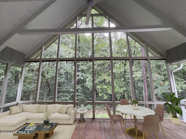 sunroom with beamed ceiling, an outdoor living space, and outdoor dining space