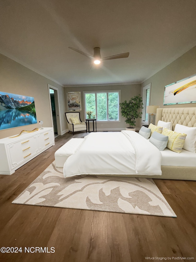 bedroom featuring a ceiling fan, wood finished floors, and ornamental molding