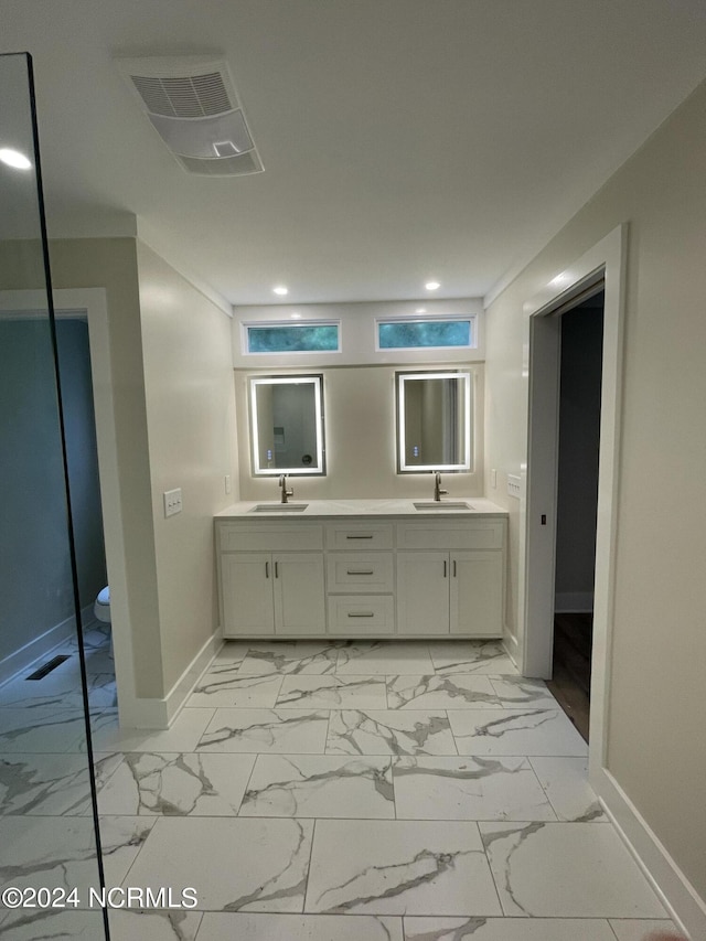 bathroom with recessed lighting, baseboards, a sink, and marble finish floor