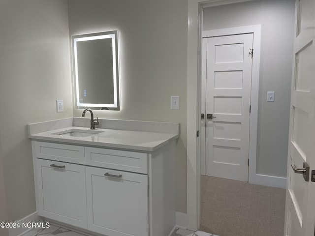 bathroom featuring baseboards, marble finish floor, and vanity