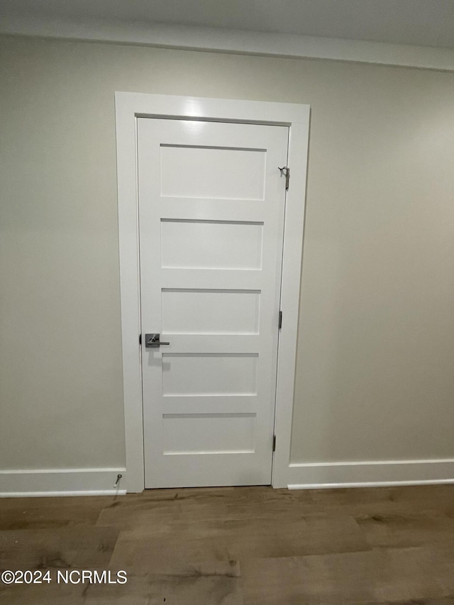 interior details with baseboards and wood finished floors