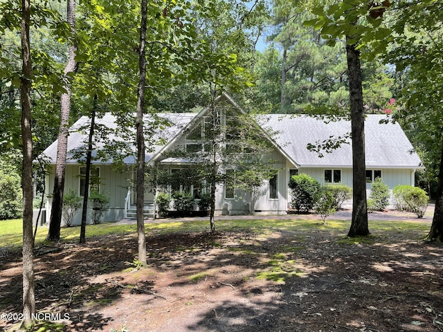 view of front of property featuring a shingled roof and board and batten siding