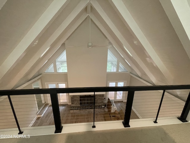 additional living space with a ceiling fan, a wealth of natural light, and vaulted ceiling with beams