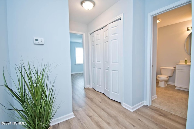 corridor with light hardwood / wood-style flooring