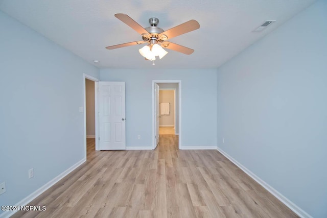 unfurnished bedroom with ceiling fan and light wood-type flooring